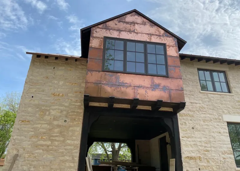 Copper metal panel facade on a stone building for Metal Roof Coating in Crestwood